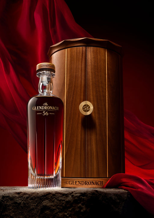Glendronach 56 year old whisky presented in a premium wooden box with a dark red backdrop.